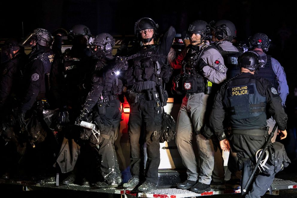 PHOTO: Portland police are seen in riot gear during a standoff with protesters in Portland, Ore., Aug. 16, 2020. 