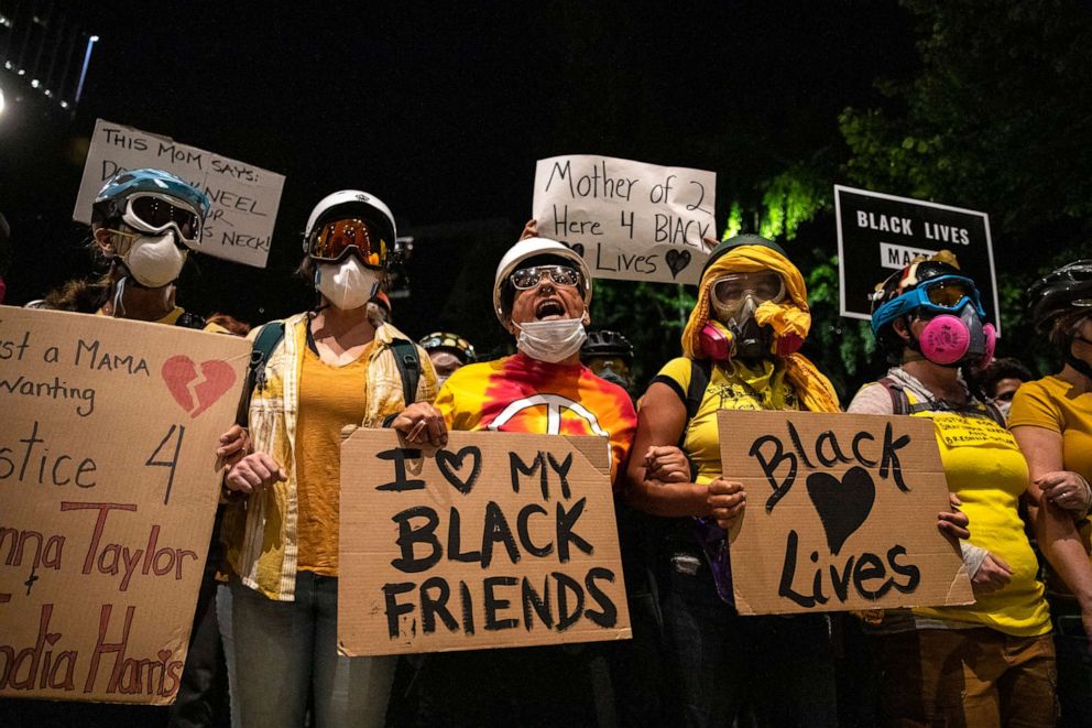 PHOTO: The Moms protest group chants slogans during a protest, July 21, 2020, in Portland, Ore. 