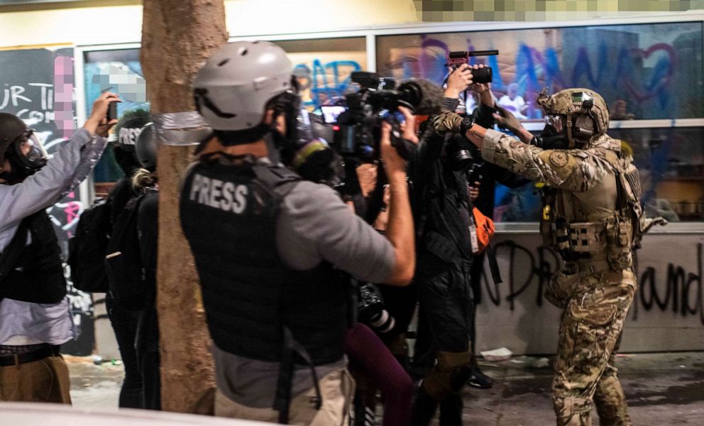 PHOTO: A federal agent confronts members of the press near Multnomah County Courthouse, the epicenter of unrest in Portland, on July 26, 2020.