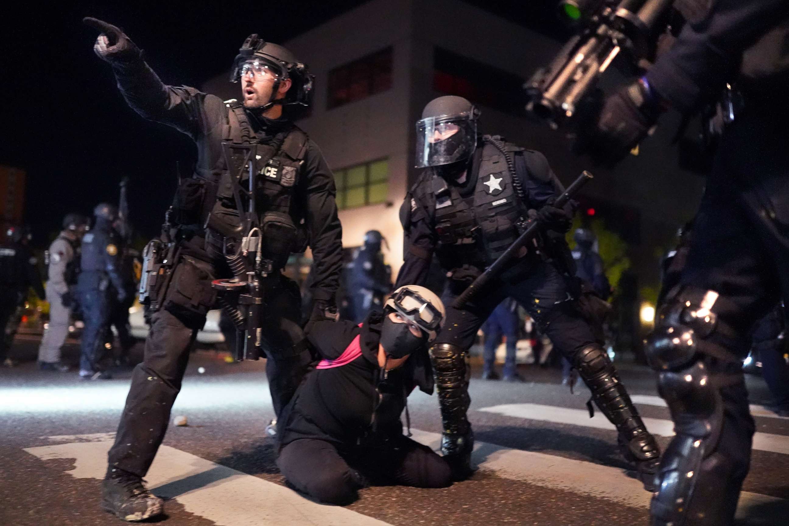 PHOTO: Portland police and Oregon State Patrol officers work together to arrest a protester on the 75th day of protests against racial injustice and police brutality, Aug. 11, 2020, in Portland.