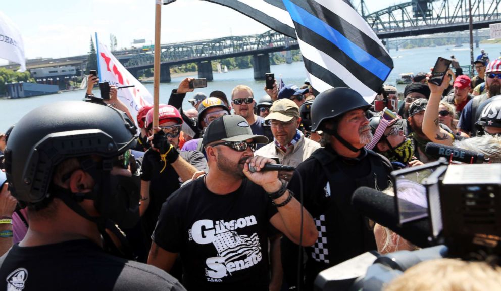 PHOTO: Joey Gibson, center, rally organizer and Patriot Prayer founder addresses alt-right activists in Portland, Oregon, August 4, 2018.