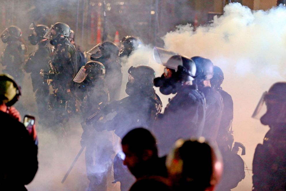 PHOTO: Police and protesters clash during a demonstration, early on Aug. 13, 2020, in downtown, Portland.