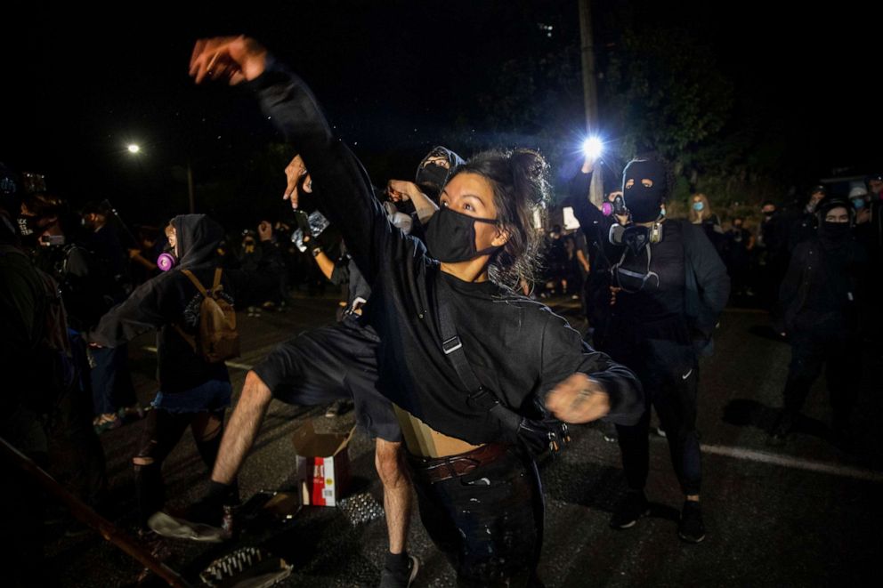 PHOTO: Protesters throw eggs at police during the nightly protests at a Portland police precinct on Aug. 30, 2020 in Portland, Ore.