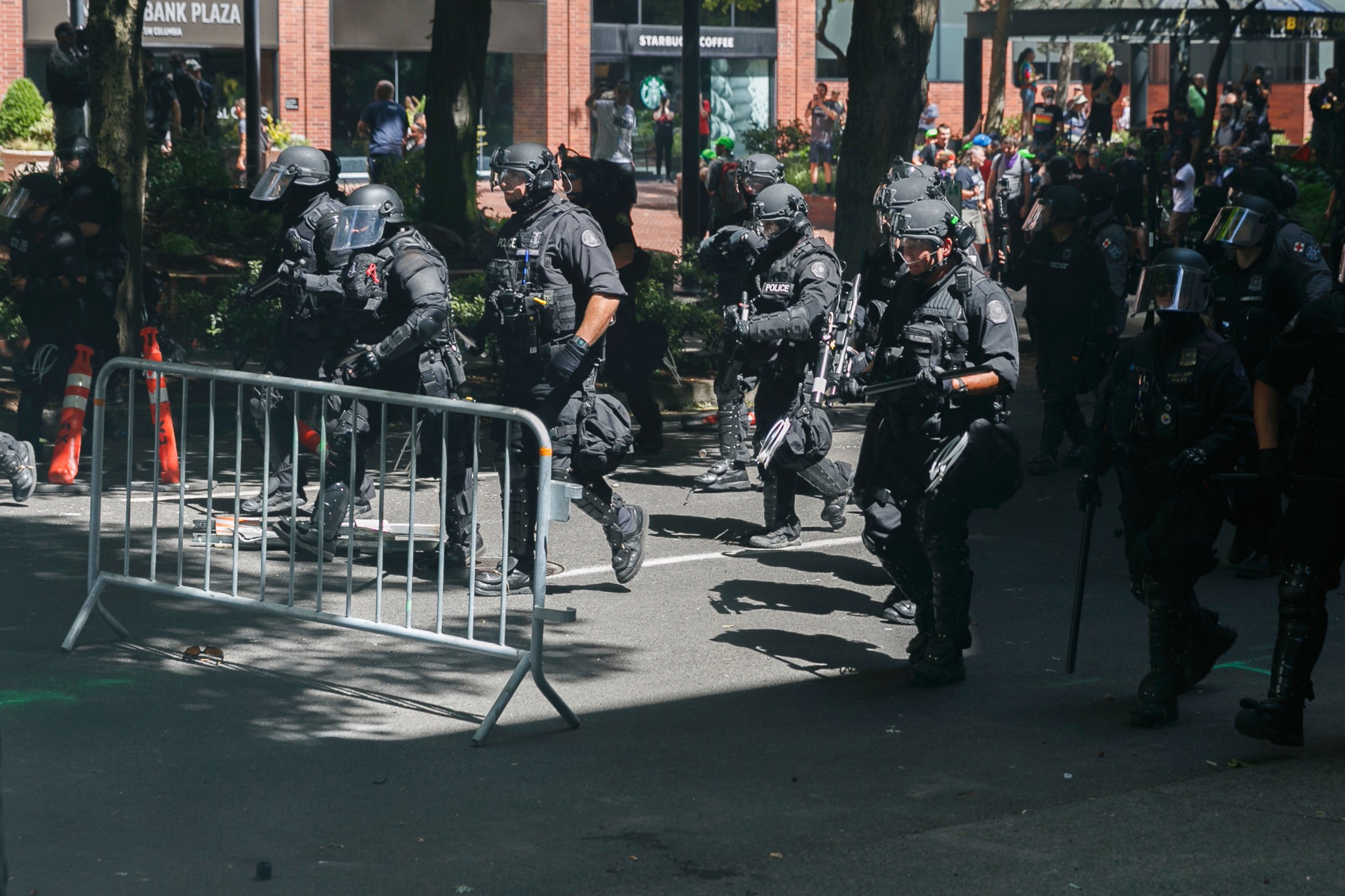 Police move in on protesters during a rally in Portland, Ore., Saturday, Aug. 4, 2018. Small scuffles broke out Saturday as police in Portland, Oregon, deployed "flash bang" devices to disperse hundreds of right-wing and anti-fascist protesters.