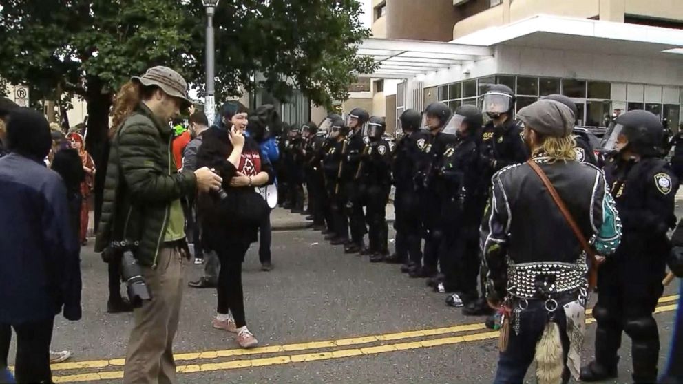 PHOTO: Police stand in a line outside the U.S. Immigration and Customs Enforcement office in Portland, Ore., June 28, 2018, where demonstrations have been held round-the-clock since June 17.