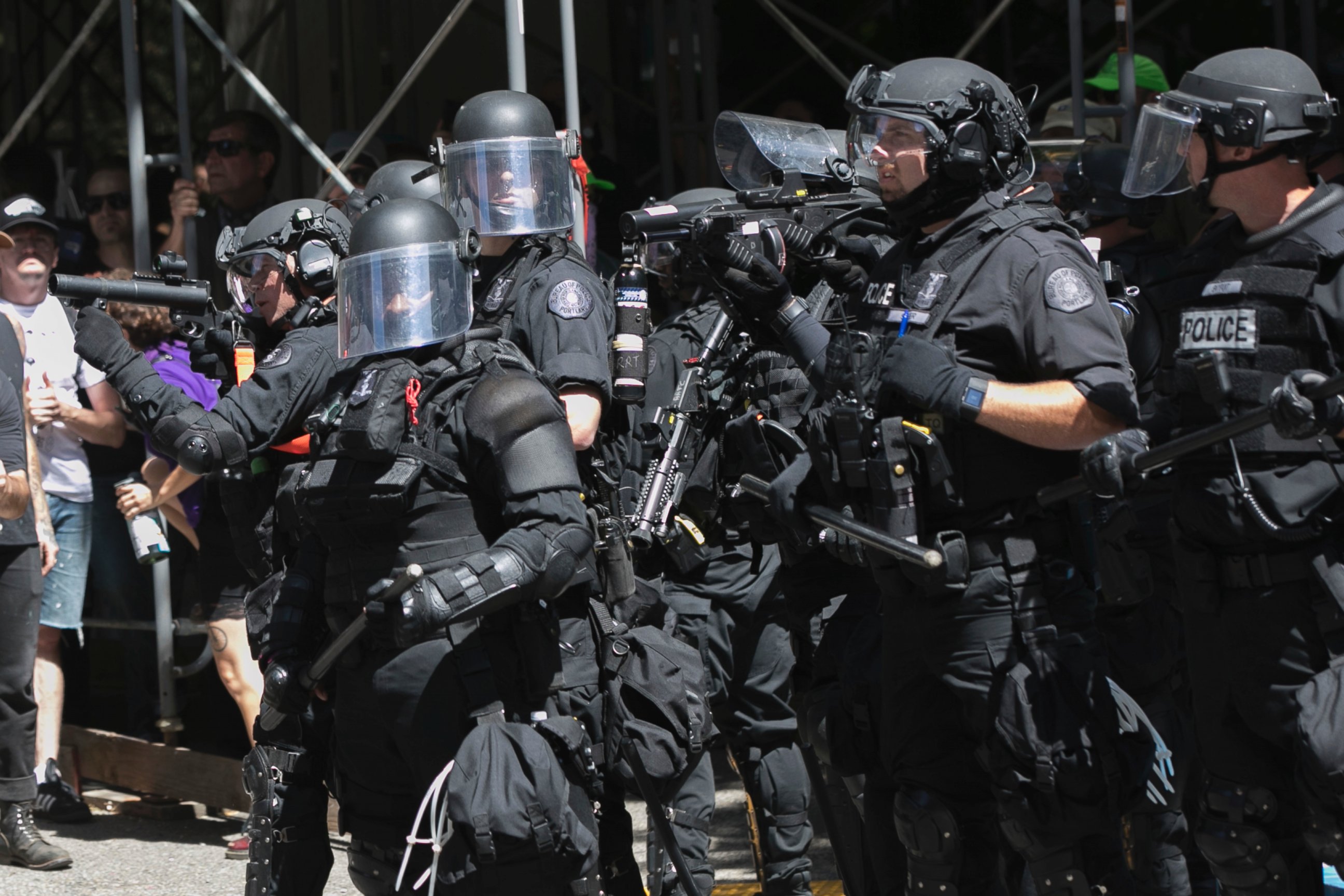 Police move in on protesters during a rally in Portland, Ore., Saturday, Aug. 4, 2018. Small scuffles broke out Saturday as police in Portland, Oregon, deployed "flash bang" devices to disperse hundreds of right-wing and anti-fascist protesters.