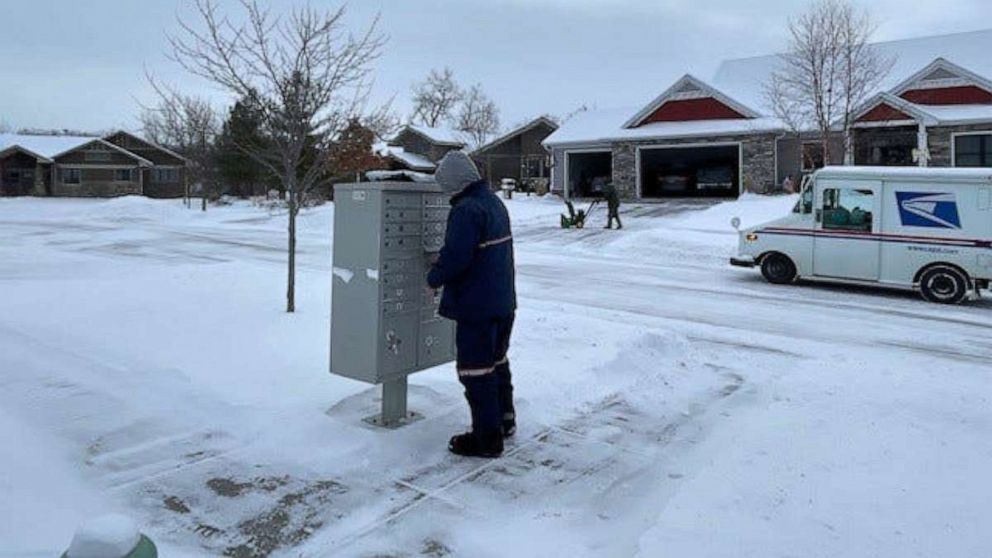 PHOTO: A United States postal worker delivers mail in Ames, Iowa, on Dec. 22, 2022. At the time, the National Weather Service reported the wind chill in Ames was minus 35 degrees.