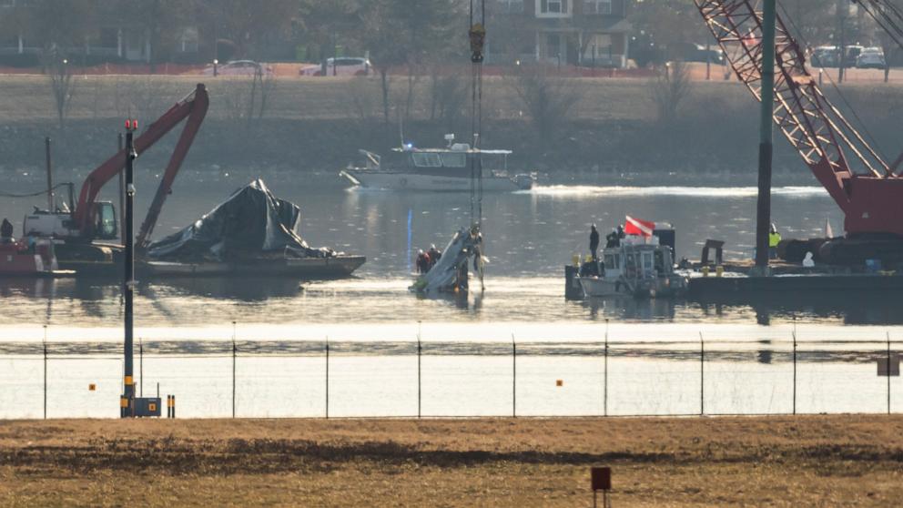 PHOTO: Salvage crews lift wreckage from the water at the site in the Potomac River of a mid-air collision between an American Airlines jet and a Black Hawk helicopter, at Ronald Reagan Washington National Airport, Feb. 4, 2025, in Arlington, Va.