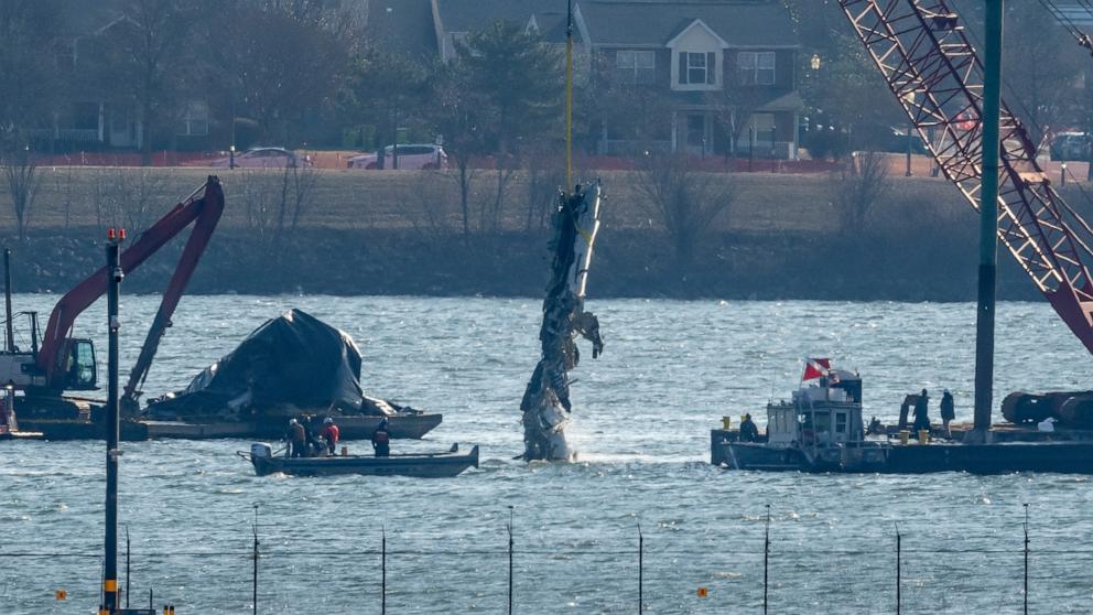 PHOTO: Wreckage is lifted from the water onto a salvage vessel near the site in the Potomac River of a collision between an American Airlines jet and a Black Hawk helicopter, at Ronald Reagan Washington National Airport, Feb. 4, 2025, in Arlington, Va.