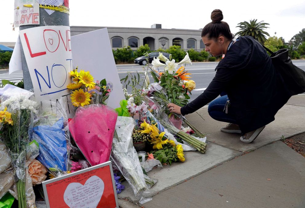 PHOTO: A woman leaves flowers on a growing memorial across the street from the Chabad of Poway synagogue in Poway, Calif., April 29, 2019, following a shooting.