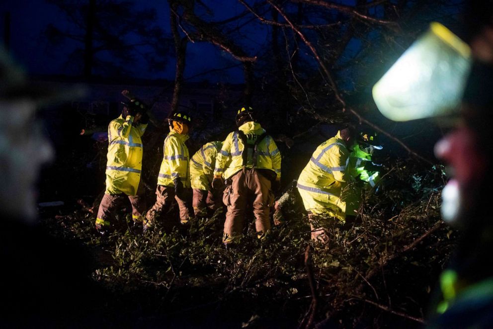 PHOTO: Montegut and Bourg firefighters cut through trees on the road in Bourg, Louisiana as Hurricane Ida passes on August 29, 2021. 