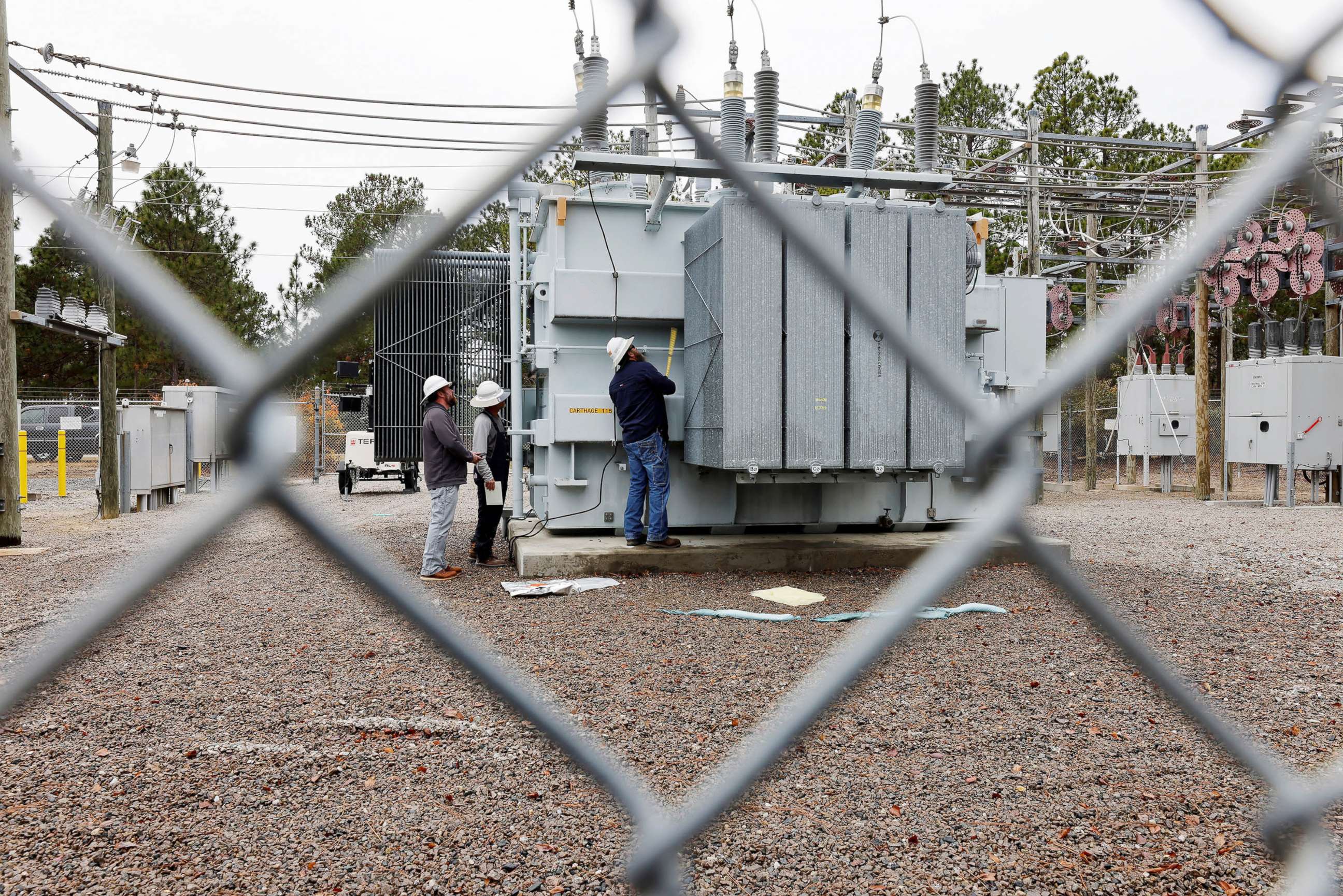 PHOTO: Duke Energy workers inspect a transformer radiator that they said was damaged by gunfire that crippled an electrical substation after the Moore County Sheriff said that vandalism caused a mass power outage, in Carthage, North Carolina, Dec. 4, 2022
