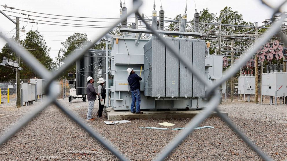 PHOTO: Duke Energy workers inspect a transformer radiator that they said was damaged by gunfire that crippled an electrical substation after the Moore County Sheriff said that vandalism caused a mass power outage, in Carthage, North Carolina, Dec. 4, 2022