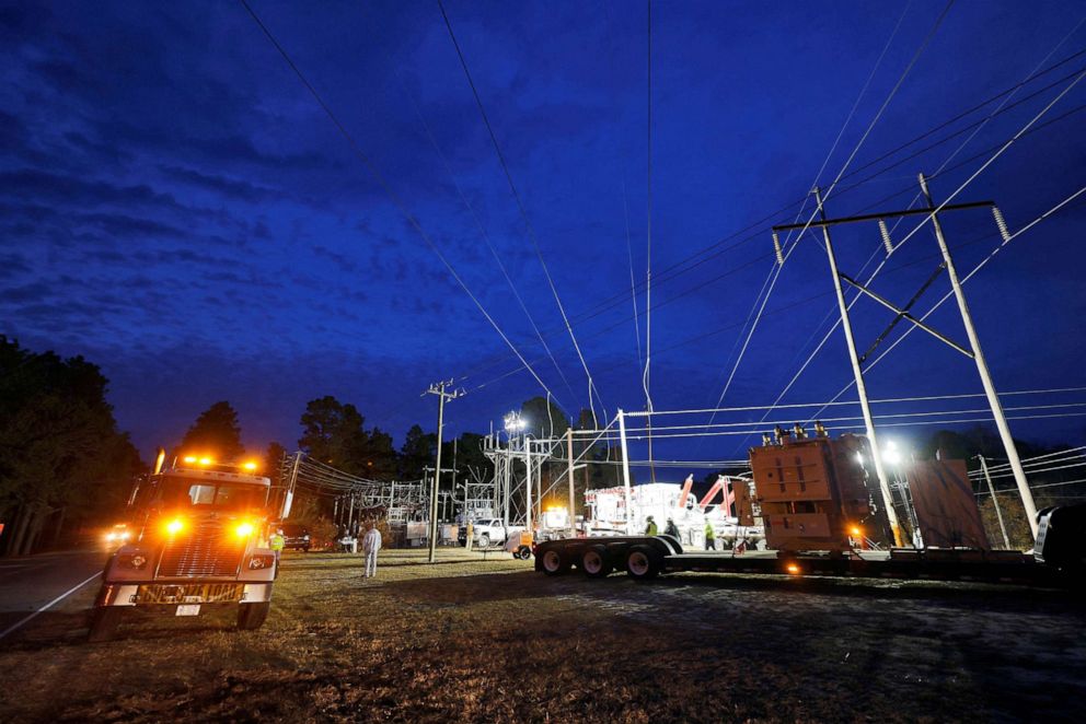 PHOTO: Duke Energy personnel work to restore power at a crippled electrical substation that the workers said was hit by gunfire after the Moore County Sheriff said that vandalism caused a mass power outage, in Carthage, North Carolina, Dec. 4, 2022.