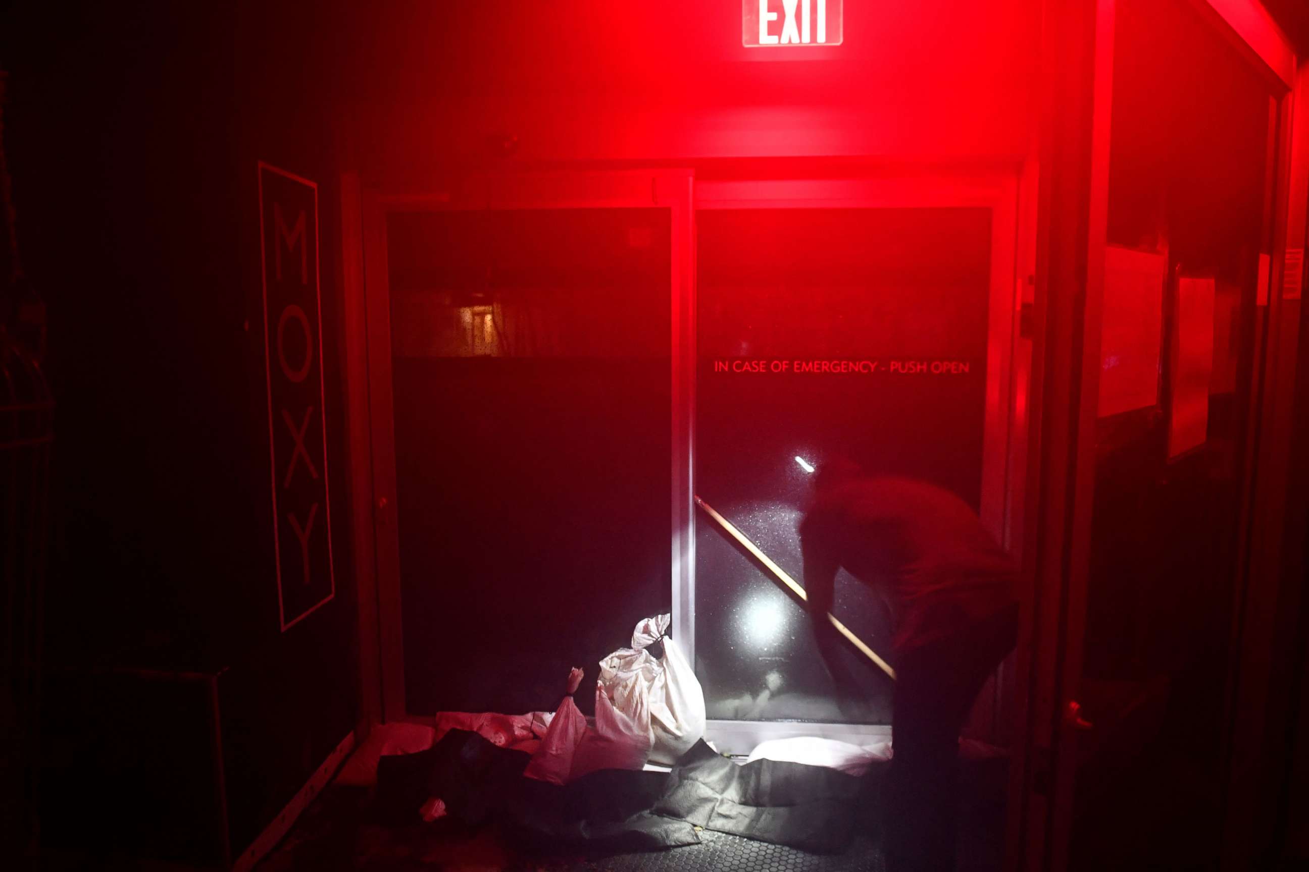 PHOTO: Hotel staff brace a door to keep it from opening in high winds after the hotel lost power in New Orleans, Louisiana on August 29, 2021 during Hurricane Ida. 