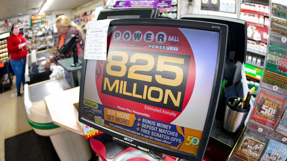 PHOTO: Customers pay for their groceries next to the lottery ticket display showing the jackpot amount for the Saturday, Oct. 29, drawing of the Powerball lottery at a market in Prospect, Pa., Oct. 28, 2022.
