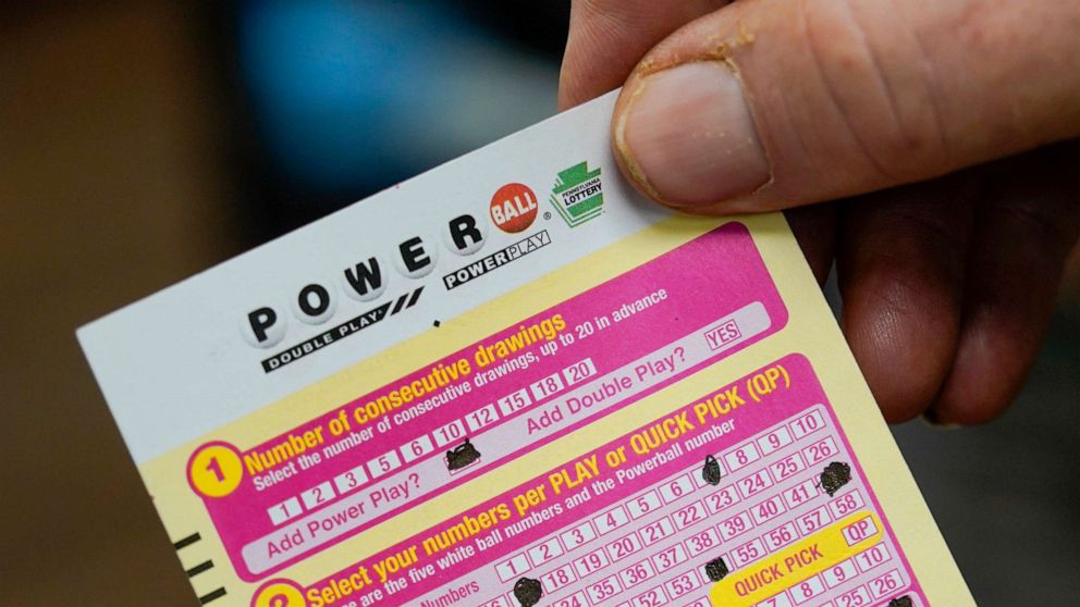 PHOTO: A customer shows his scan card for his personal selection numbers for a ticket for a Monday Powerball drawing on Nov. 7, 2022, at a convenience store in Renfrew, Pa.
