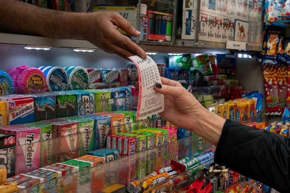 PHOTO: A person purchases a Powerball ticket in New York City on Nov. 4, 2022.