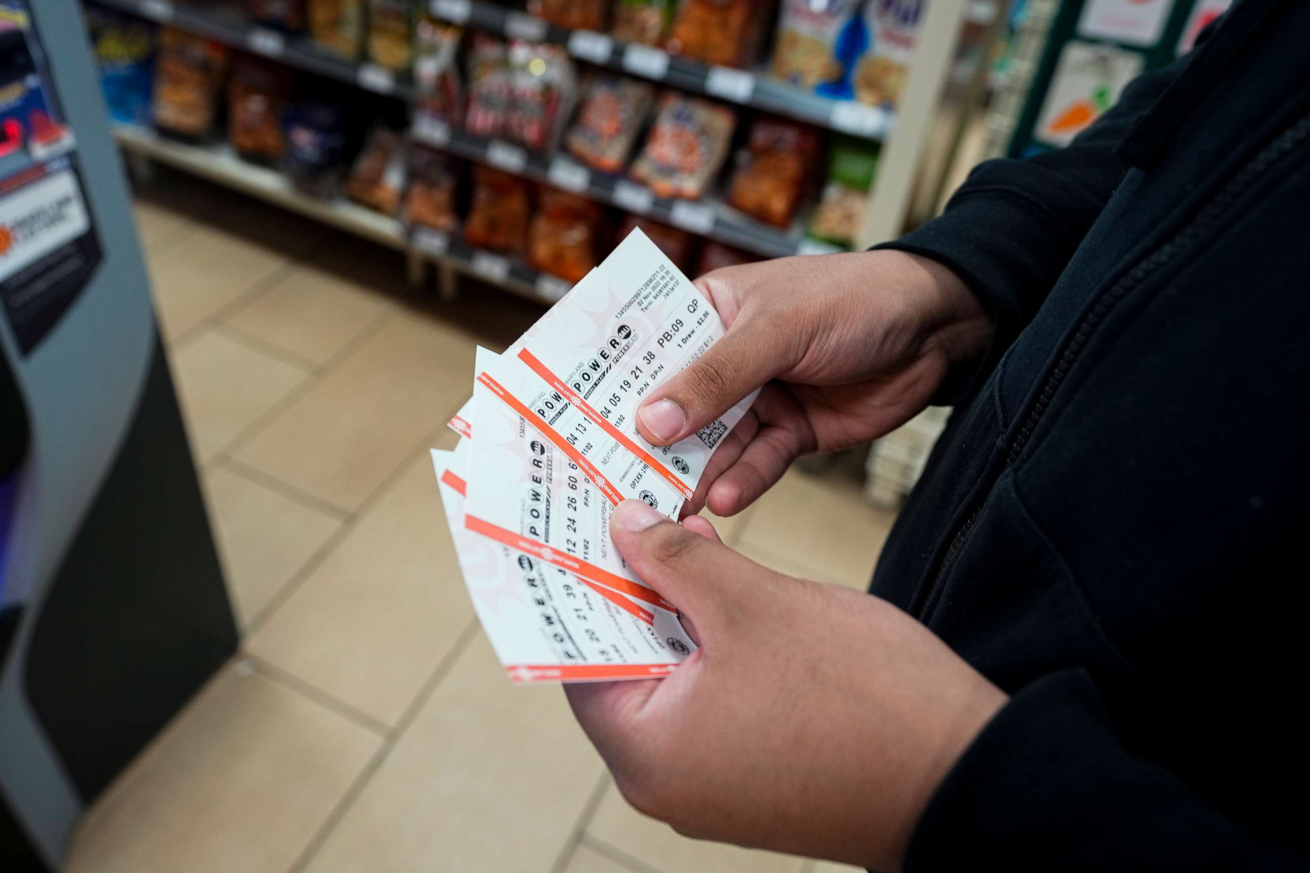 PHOTO: James Franklin, of Baltimore, holds his Powerball lottery tickets he purchased at a convenience store in Cockeysville, Maryland, on Nov. 2, 2022.