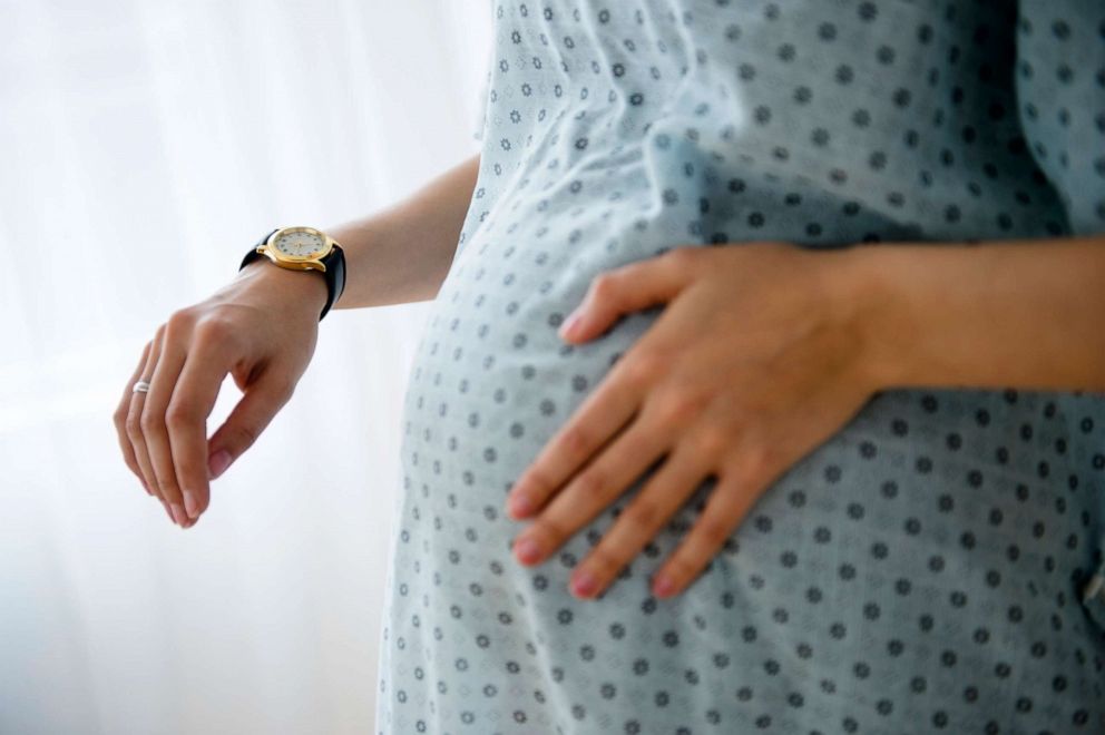 PHOTO: A pregnant woman holds her stomach in this stock photo.