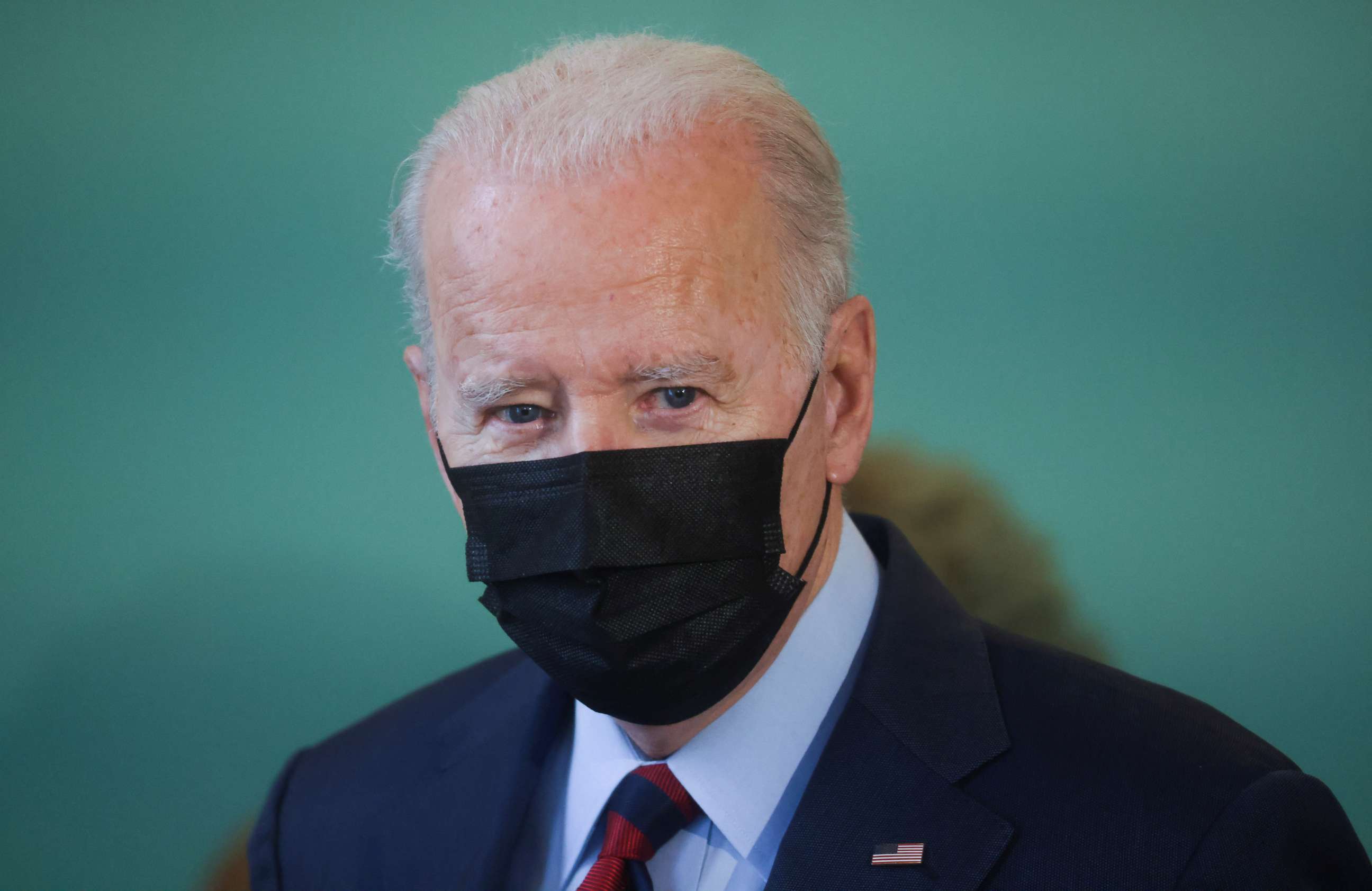 PHOTO: President Joe Biden talks to reporters about Russia and the crisis in Ukraine as he pays a visit to a small clothing and gifts store on Capitol Hill in Washington, Jan. 25, 2022.