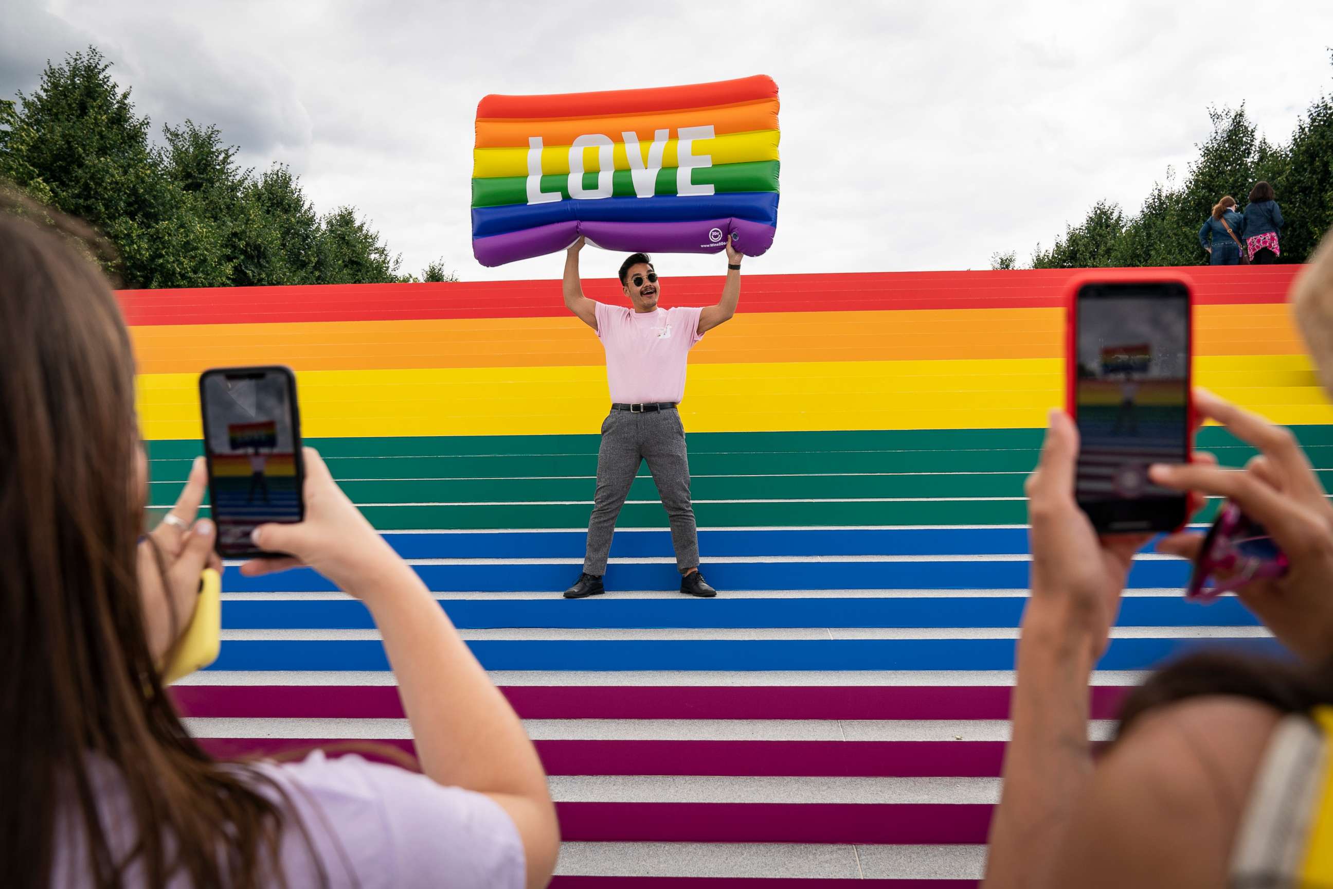 PHOTO: Lorenzo Soler poses for photos on the steps that are covered in rainbow colors for Pride Month at Franklin D. Roosevelt Four Freedoms Park, June 14, 2019 on Roosevelt Island in New York.