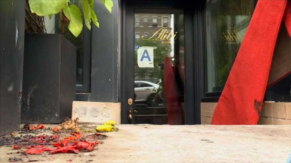 PHOTO: The charred remains of a rainbow pride flag sit on the ground outside the Alibi Lounge in the Harlem borough of New York after it was burned by a vandal, July 8, 2019.