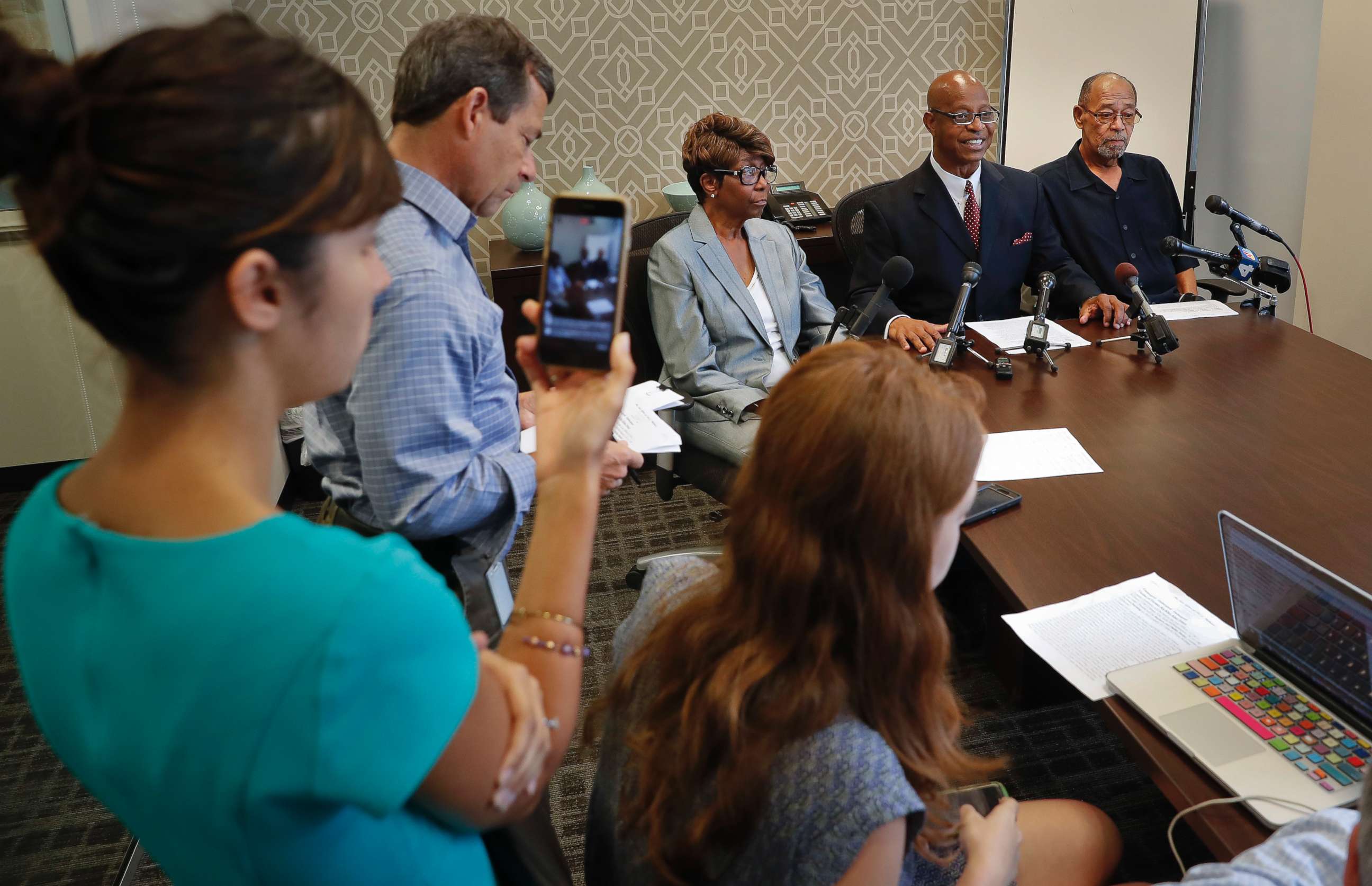 PHOTO: Attorney Ted Williams, right center, for Barbara, center, and Phillip Butler, right, victims of a cross burning on their property forty years ago, speaks during a news conference at Williams office in Washington, Aug. 23, 2017.