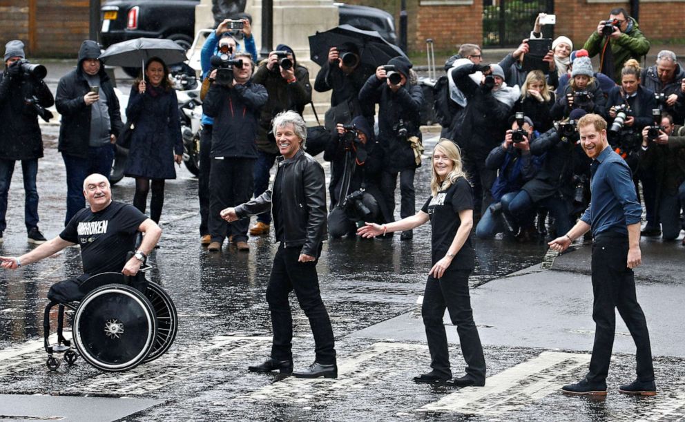 PHOTO: Britain's Prince Harry, singer Jon Bon Jovi and two members of the Invictus Games Choir re-create the iconic Beatles Abbey Road album cover walk at the Abbey Road Studios in London, Feb. 28, 2020.