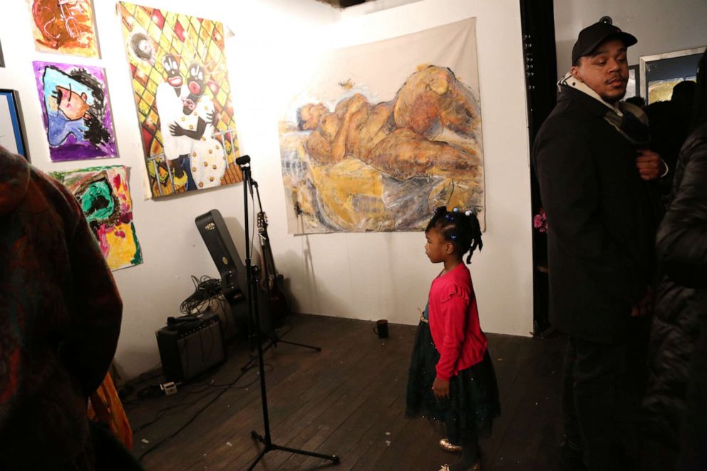 PHOTO: Princess stares at her painting titled "Maps" hanging on Mark West's gallery wall.