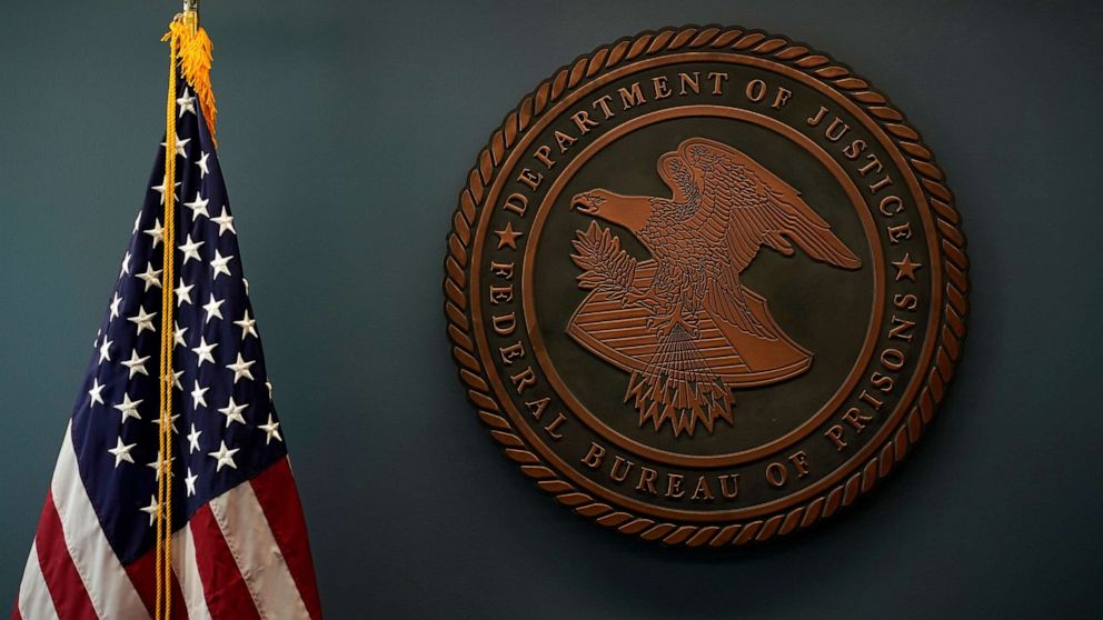 PHOTO: An American flag and the seal for the Federal Bureau of Prisons is seen at Federal Bureau of Prisons headquarters in Washington, D.C., Oct. 24, 2022.