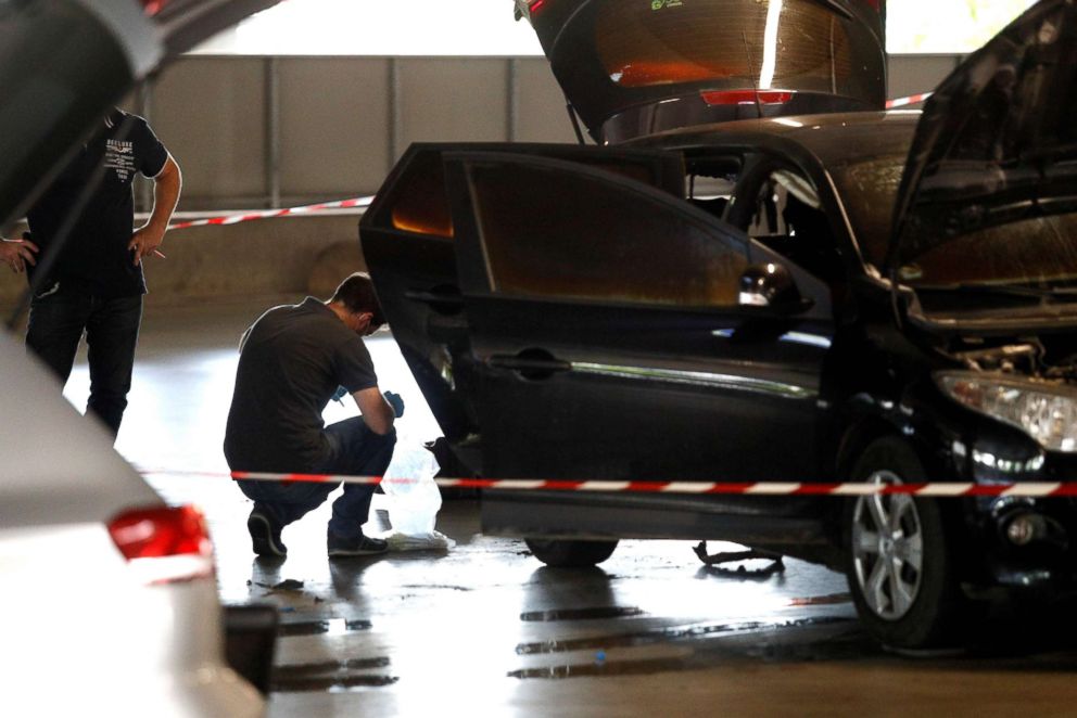 PHOTO: This picture taken on July 1, 2018 in Aulnay-sous-Bois, shows a forensic police officer investigating a car abandoned by French armed robber Redoine Faid at O'Parinor shopping mall parking after his escape onboard a helicopter from a prison.