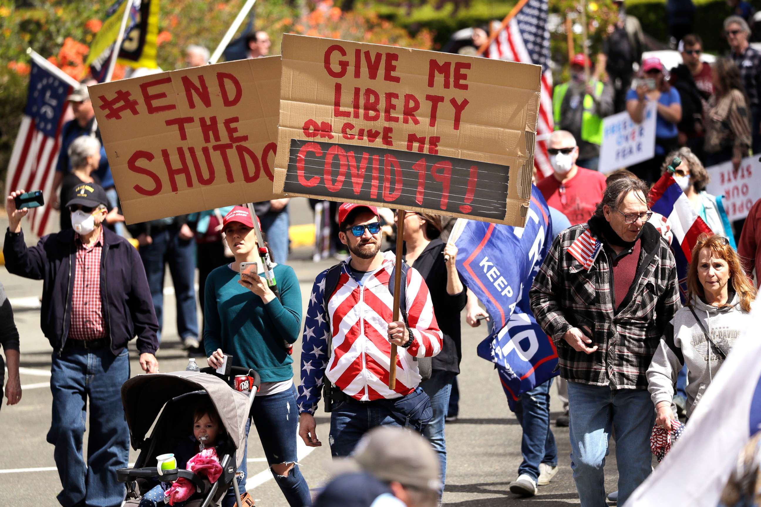 PHOTO: Demonstrators begin to gather at a protest opposing Washington state's stay-home order to slow the coronavirus outbreak, April 19, 2020, in Olympia, Wash. 