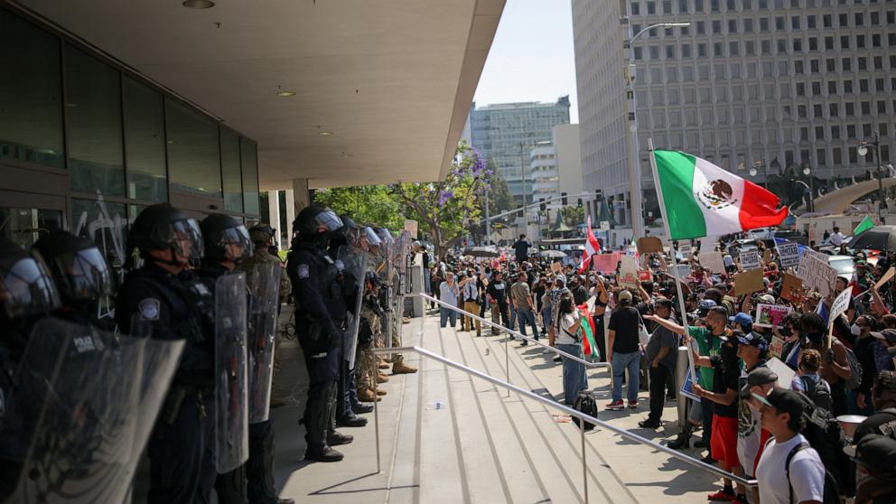 PHOTO: Law enforcement officers stand guard, as protests against immigration sweeps continue, in Los Angeles, June 9, 2025.