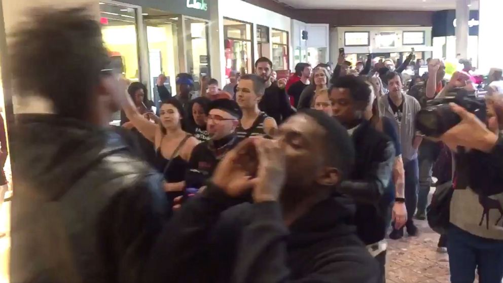 People chant in protest at the Galleria Mall, located near St.Louis, Missouri, Nov. 24, 2017.