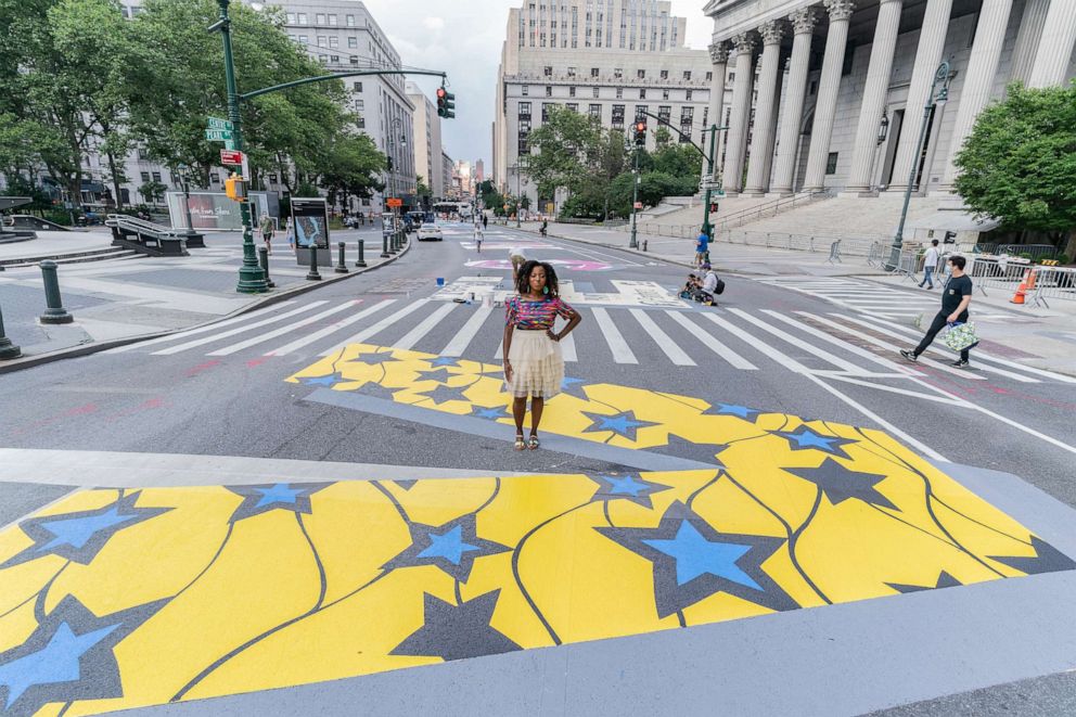 PHOTO: Designer of characters for word "Lives" Sophia Dawson seen at Centre street mural "Black Lives Matter" in New York, July 3, 2020.