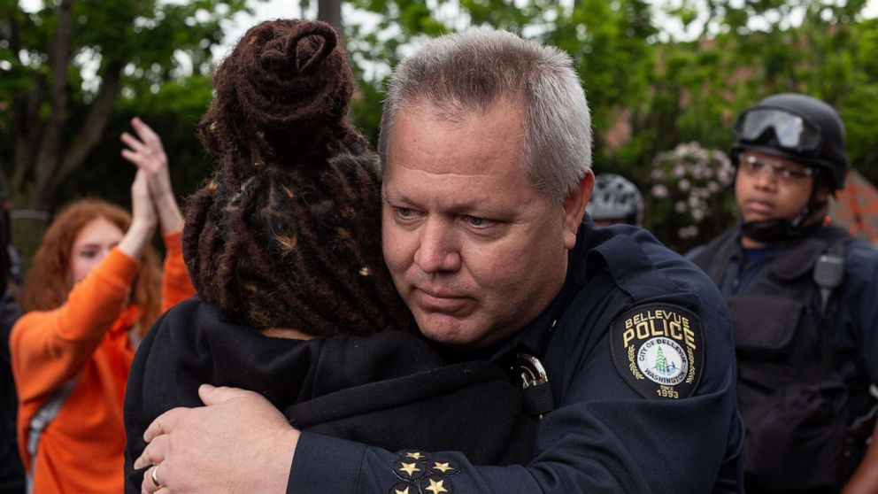 PHOTO: Bellevue Police Chief Steve Mylett hugs a demonstrator during a gathering to protest the recent death of George Floyd on May 31, 2020 in Bellevue, Washington. 