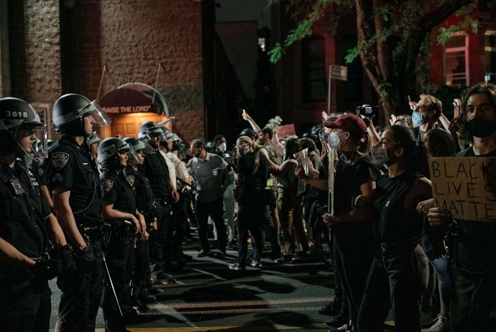 PHOTO: Demonstrators denouncing systemic racism in law enforcement face off with a line of NYPD officers hours after violating a citywide curfew on June 4, 2020, in New York.