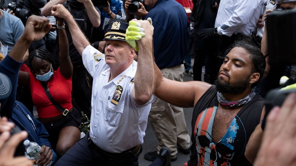 PHOTO: Chief of Department of the New York City Police, Terence Monahan, takes a knee with activists as protesters paused while walking in New York, June 1, 2020. 