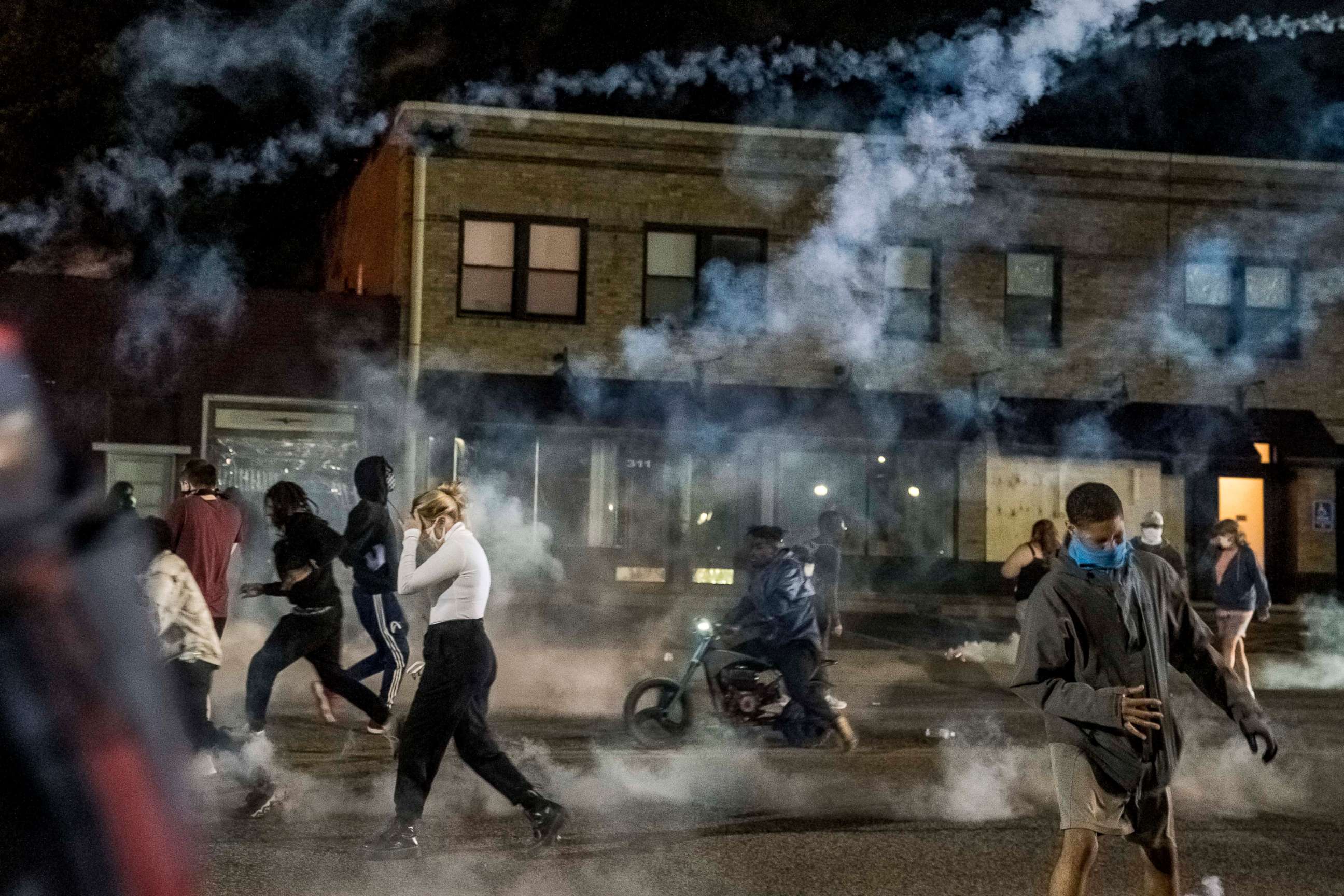 PHOTO: Tear gas is deployed on a crowd of protesters in Ferguson, Mo., on Sunday, May 31, 2020.