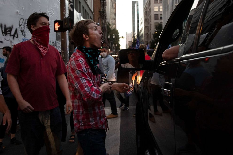 PHOTO: A Black Lives Matter protester yells at a supporter of President Donald Trump  during a rally and car parade in Portland, Oregon, on Aug. 29, 2020. 