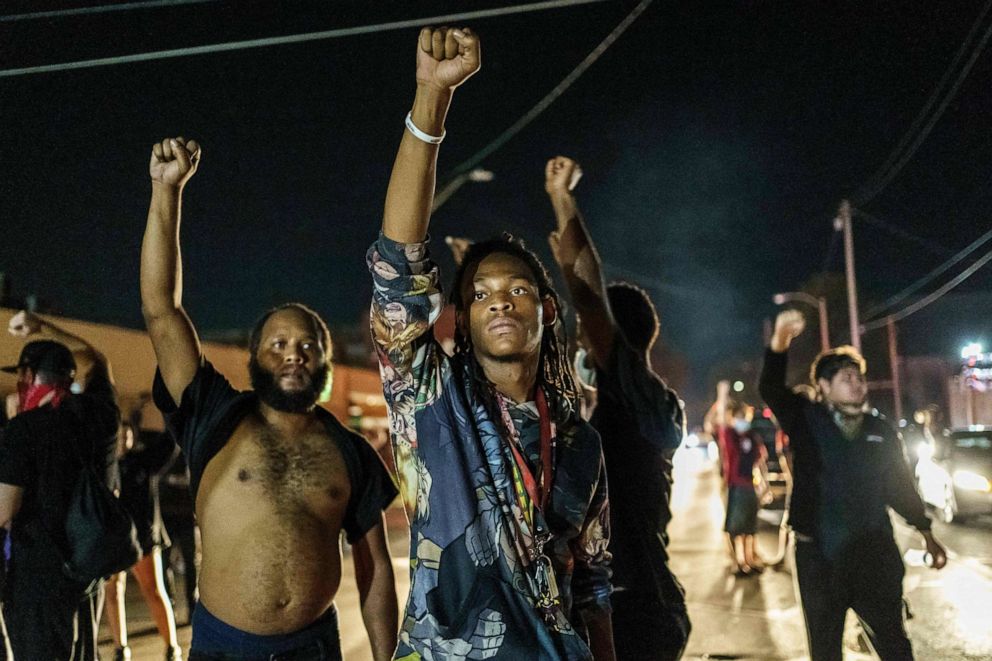 PHOTO: Protesters raise their fists during a demonstration against the police shooting of Jacob Blake in Kenosha, Wisconsin, on Aug. 26, 2020.