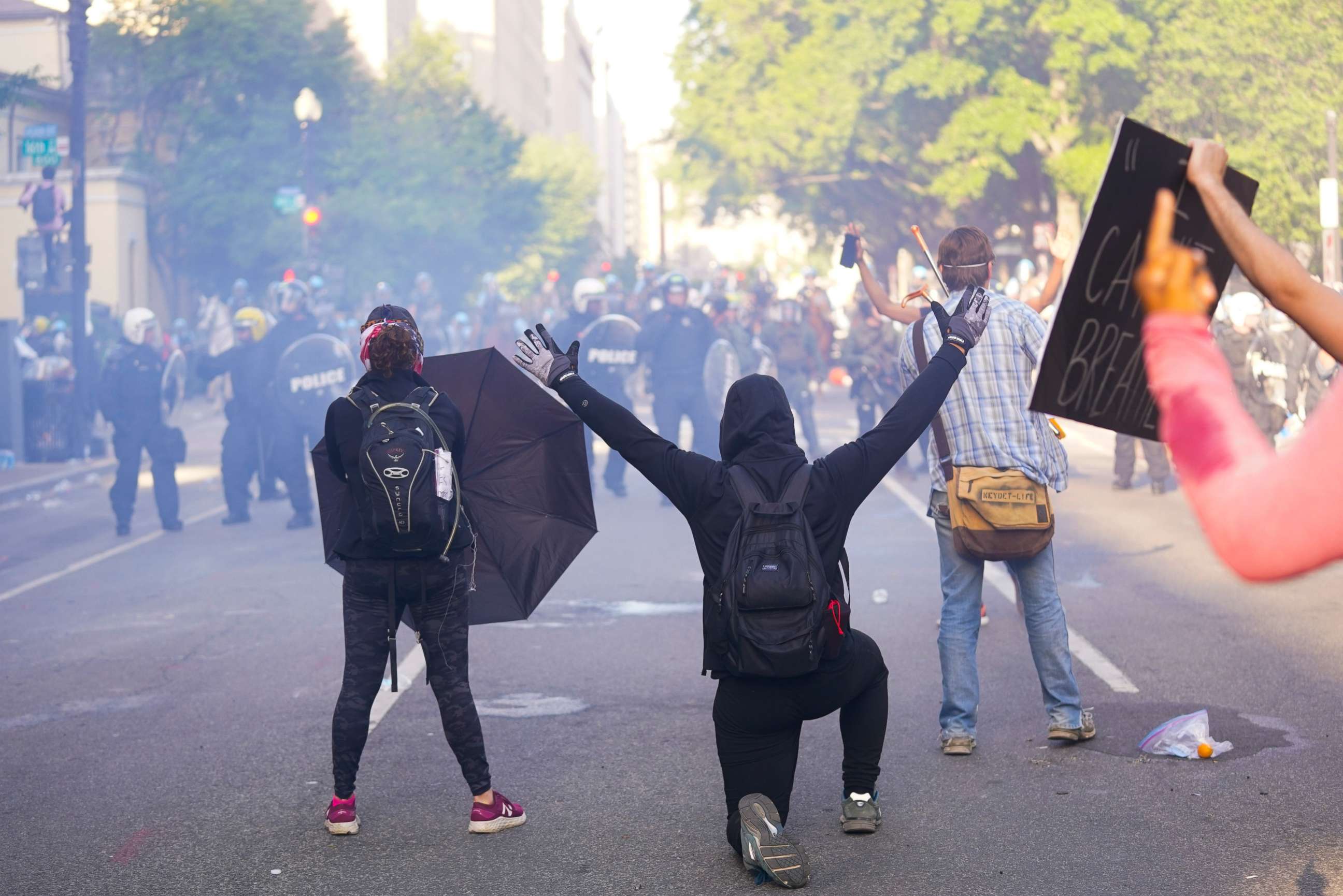 PHOTO: Demonstrators kneel in front of a line of police officers during a protest for the death of George Floyd, Monday, June 1, 2020, near the White House in Washington.