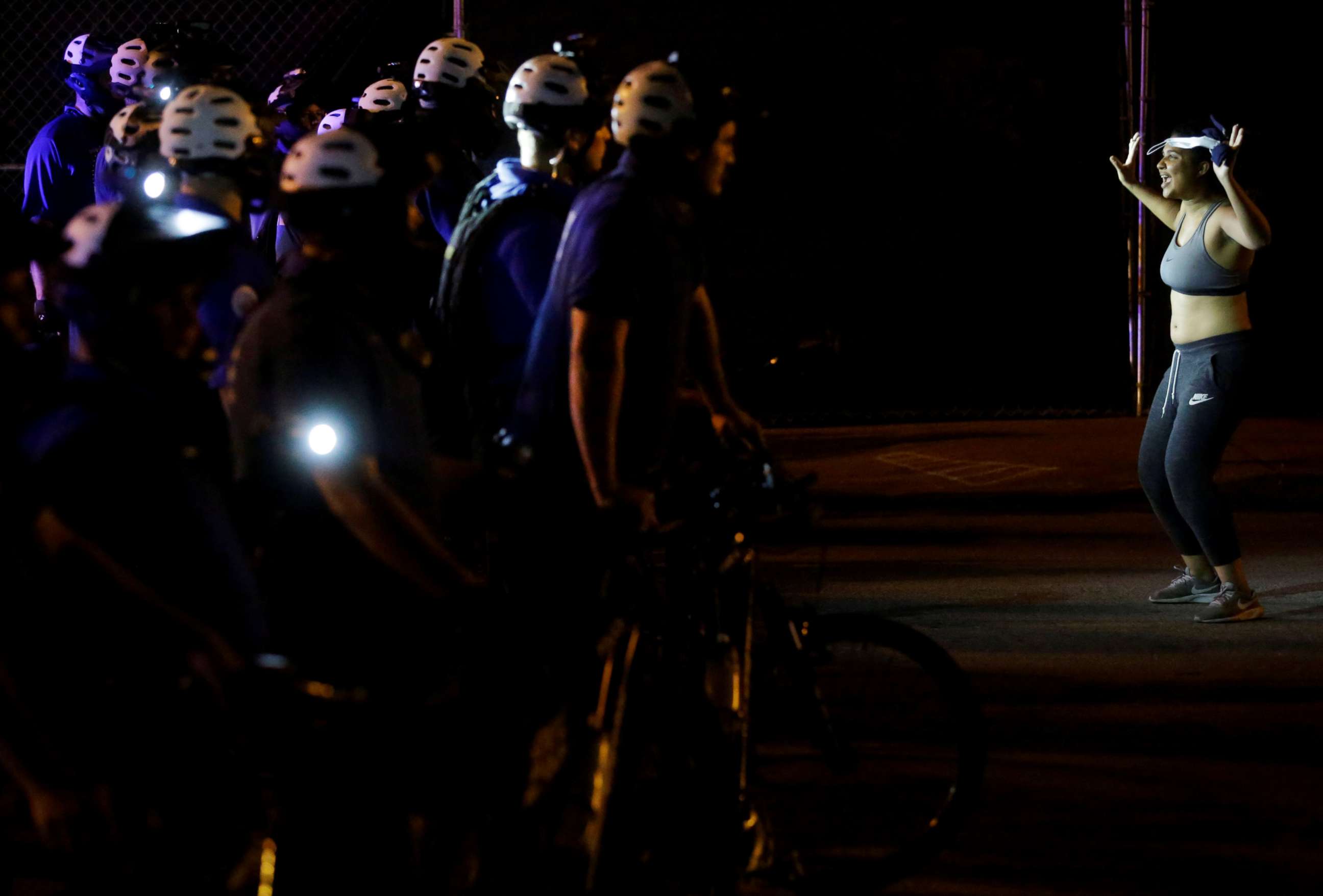 PHOTO: Police officers watch a demonstrator as she confronts them during a protest for the not guilty verdict in the murder trial of Jason Stockley, in St. Louis, Sept. 17, 2017. 