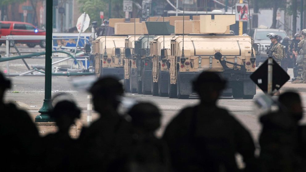 PHOTO: Armored vehicles line the street as National Guard members guard the area in the aftermath the third night of violent protests, May 29, 2020, in Minneapolis, over the death of  George Floyd.