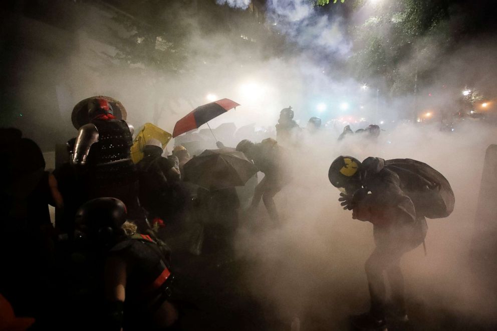 PHOTO: Federal officers launch tear gas at a group of demonstrators during a Black Lives Matter protest at the Mark O. Hatfield United States Courthouse, July 26, 2020, in Portland, Ore.