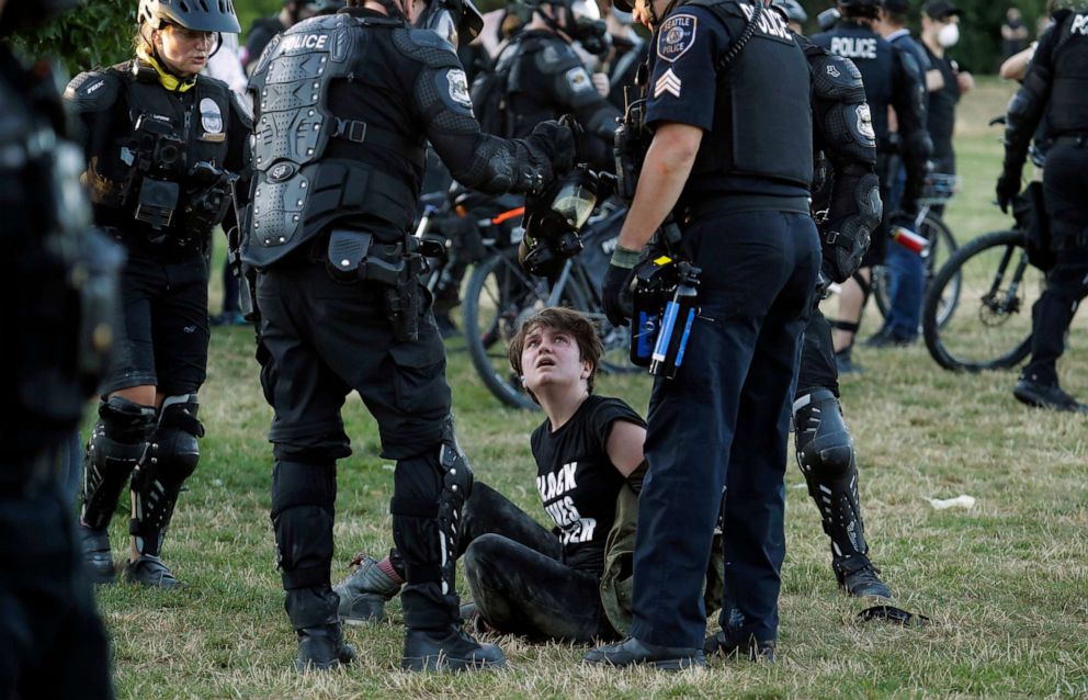PHOTO: A person is arrested by Seattle Police at Cal Anderson Park, July 25, 2020, during a Black Lives Matter protest near the Seattle Police East Precinct headquarters.