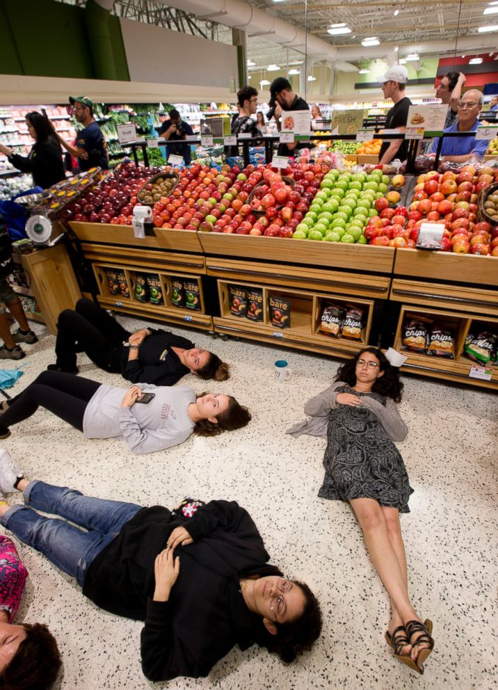 Demonstrators lie on the floor at a Publix Supermarket in Coral Springs, Fla., Friday, May 25, 2018.