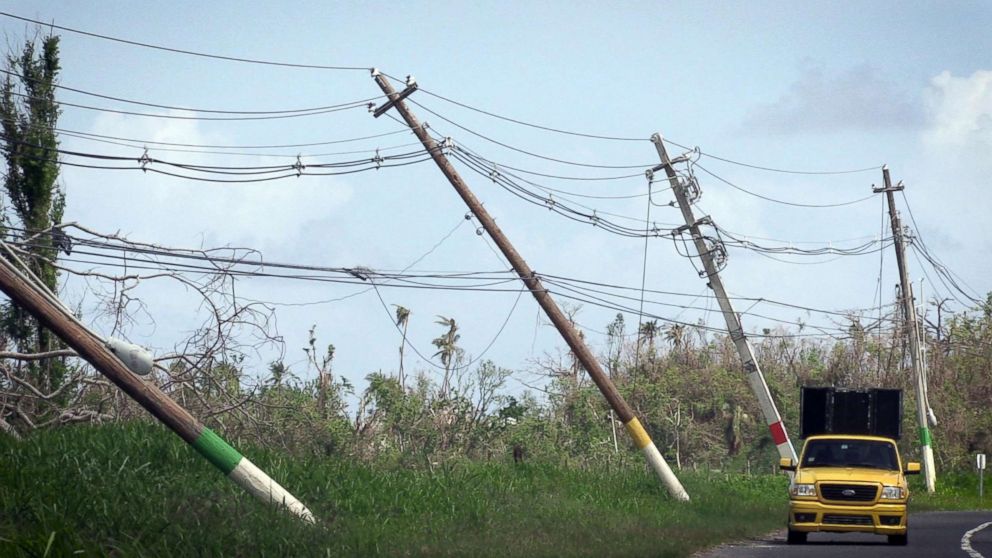 PHOTO: Power lines hang precariously, Oct. 14, 2017, on the side of the road on highway 118 near San Isidro, Puerto Rico.