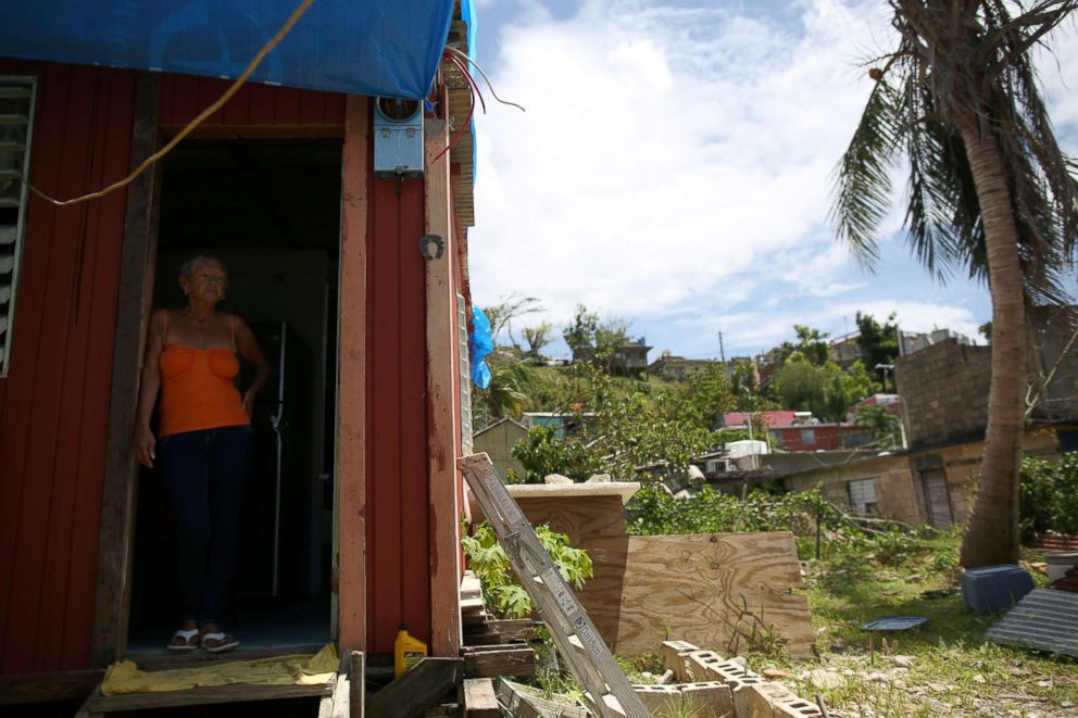 PHOTO: Bexaida Torres stands in the door of what is left of her home after Hurricane Maria hit the island in September, in a neighbourhood in Canovanas, Puerto Rico, April 10, 2018.